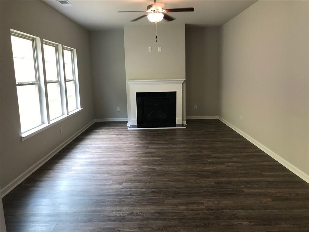 213 Creek View Place Canton, GA 30114 - Photo 2 of 10 a view of an empty room with wooden floor fireplace and a window