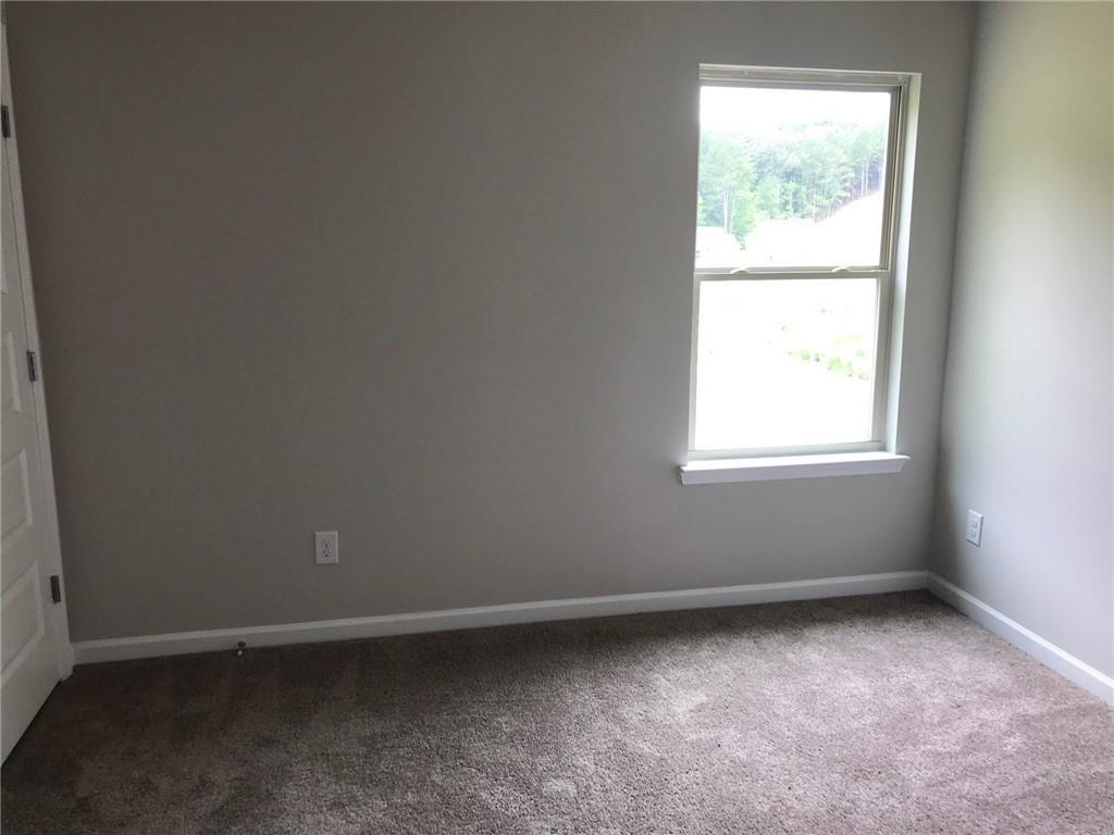 213 Creek View Place Canton, GA 30114 - Photo 7 of 10 an empty room with a window