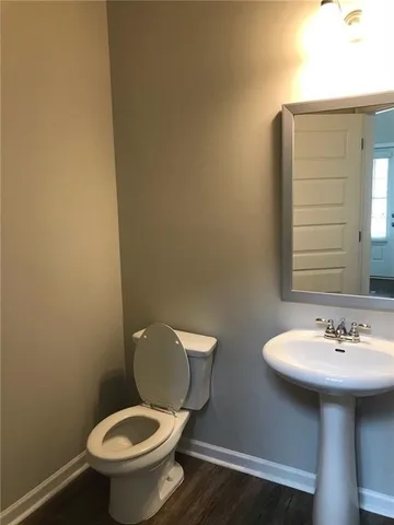 a white toilet sitting next to a bathroom sink