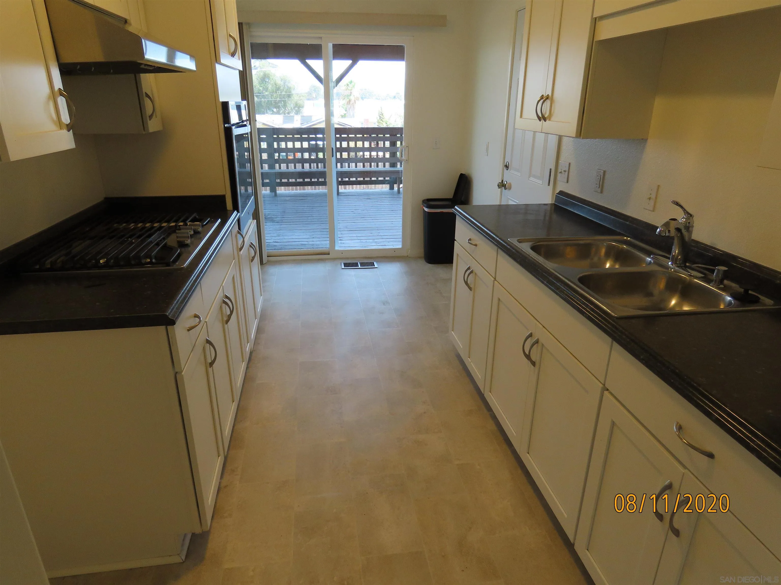 633 El Monte Road El Cajon, CA 92020 - Photo 3 of 18 a kitchen with a sink a stove cabinets and a window