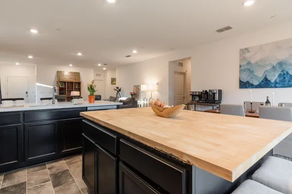 a kitchen with kitchen island a sink appliances and cabinets