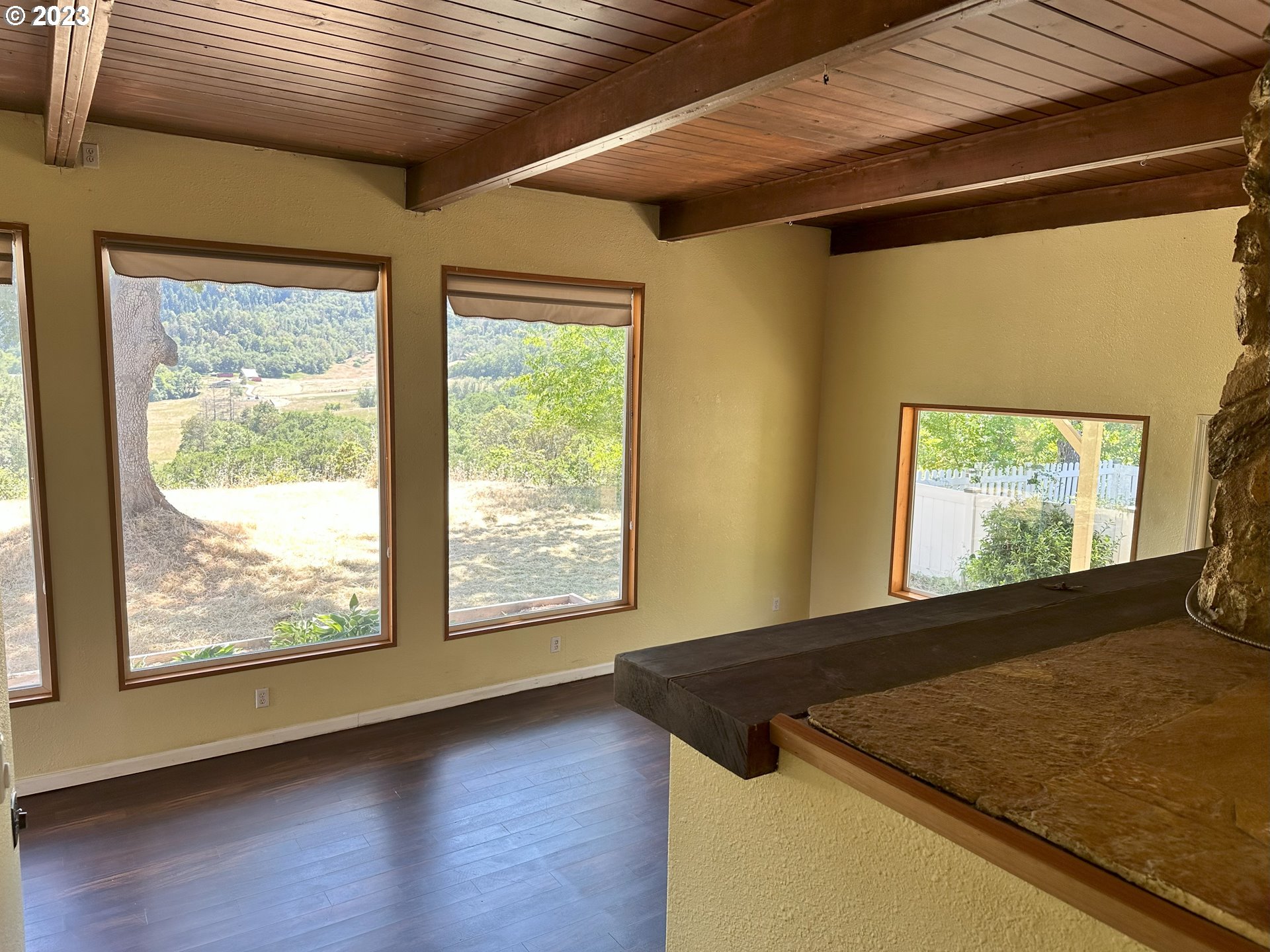 979 Evergreen Ridge Road Riddle, OR 97469 - Photo 12 of 41 a view of a room with wooden floor and a window