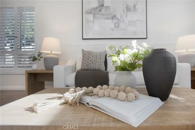 a kitchen with a sink a stove and chairs with wooden floor