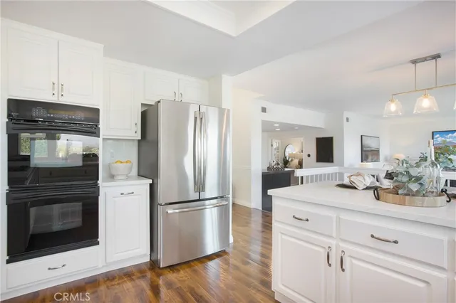 a living room with furniture a fireplace and a floor to ceiling window