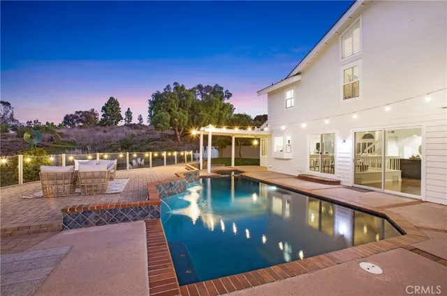 a view of a house with a yard and potted plants