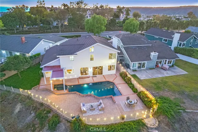 a view of a swimming pool with a patio and a yard
