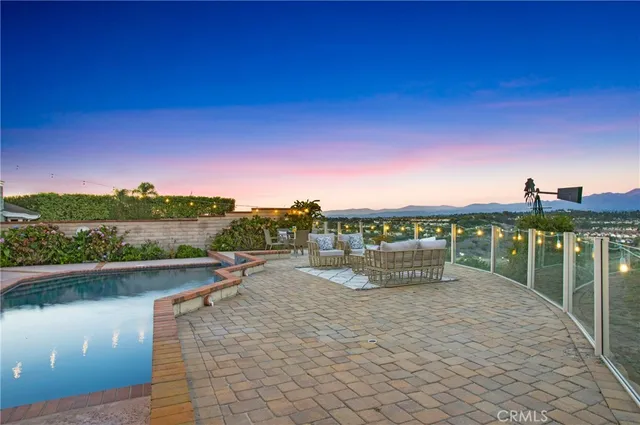 a living room with furniture large window and wooden floor
