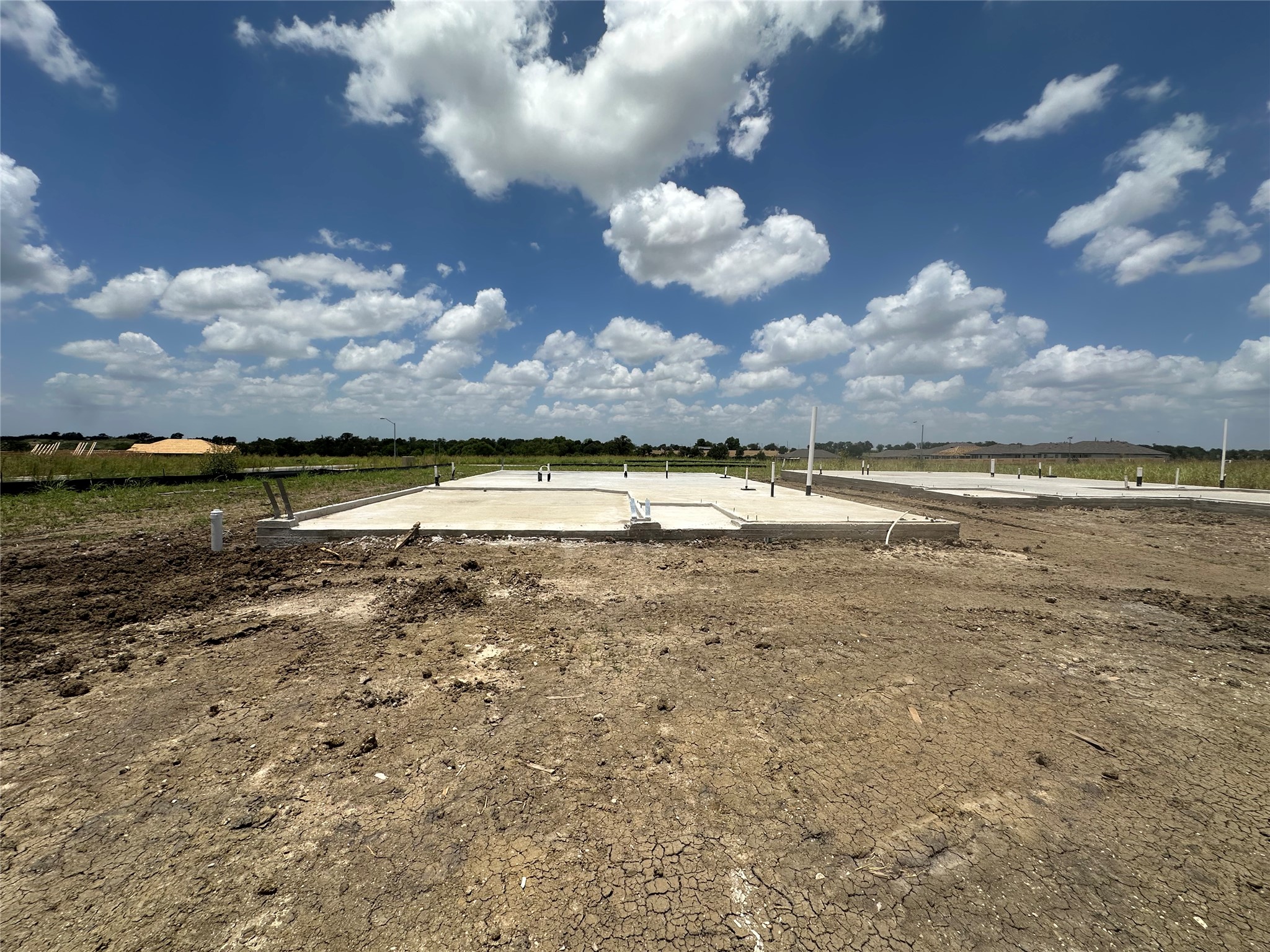 13804 Ryan Range Lane Elgin, TX 78621 - Photo 6 of 23 A new construction site with poured concrete foundations awaits future development.