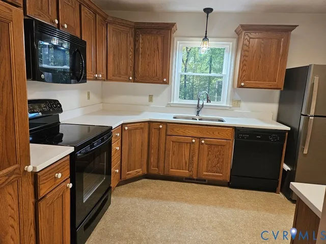 a kitchen with a sink stove and microwave
