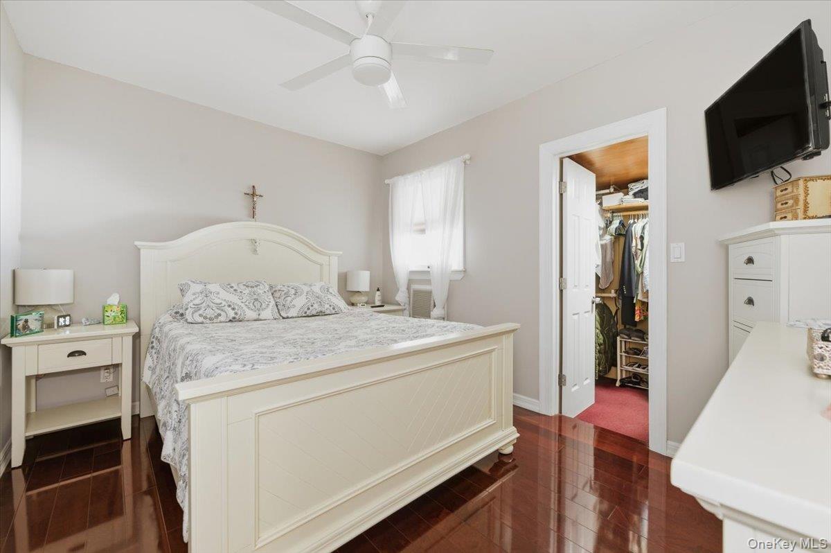 80 Newport Road Island Park, NY 11558 - Photo 11 of 26 a room with a bed and a flat screen tv