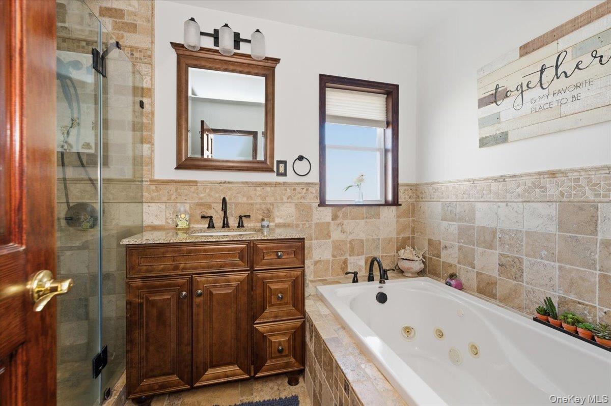 80 Newport Road Island Park, NY 11558 - Photo 12 of 26 a bathroom with a tub sink and mirror