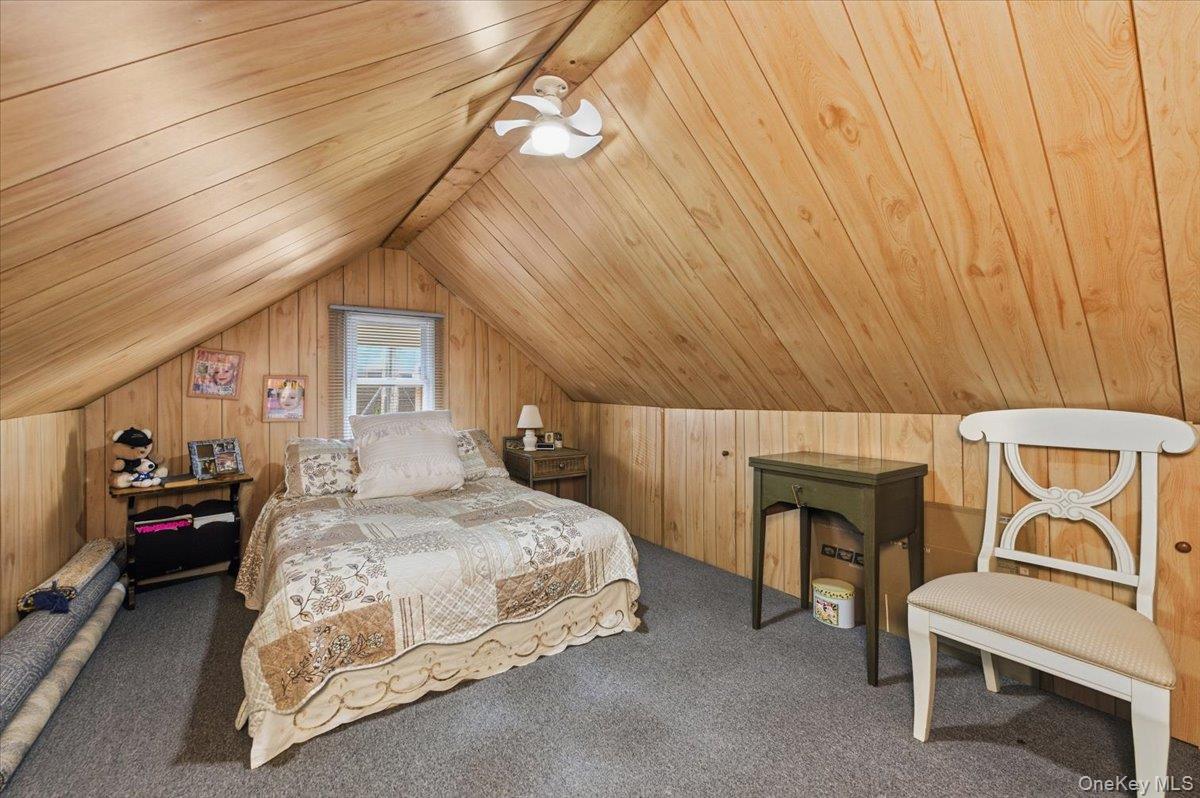 80 Newport Road Island Park, NY 11558 - Photo 14 of 26 a bedroom with a bed and a chair