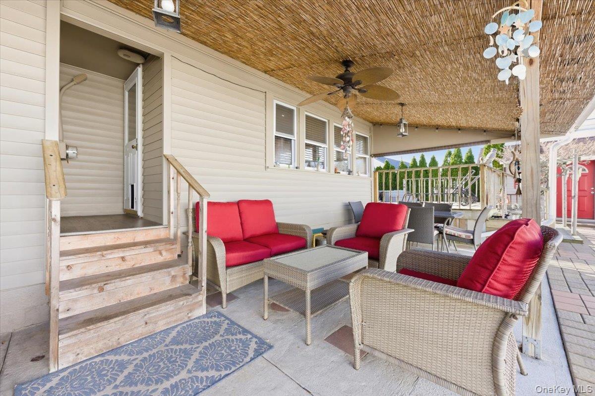 80 Newport Road Island Park, NY 11558 - Photo 16 of 26 a balcony with furniture and a potted plant