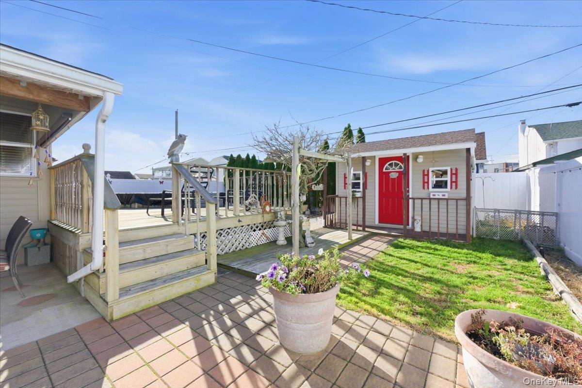 80 Newport Road Island Park, NY 11558 - Photo 17 of 26 a view of a patio with couches table and chairs and potted plants