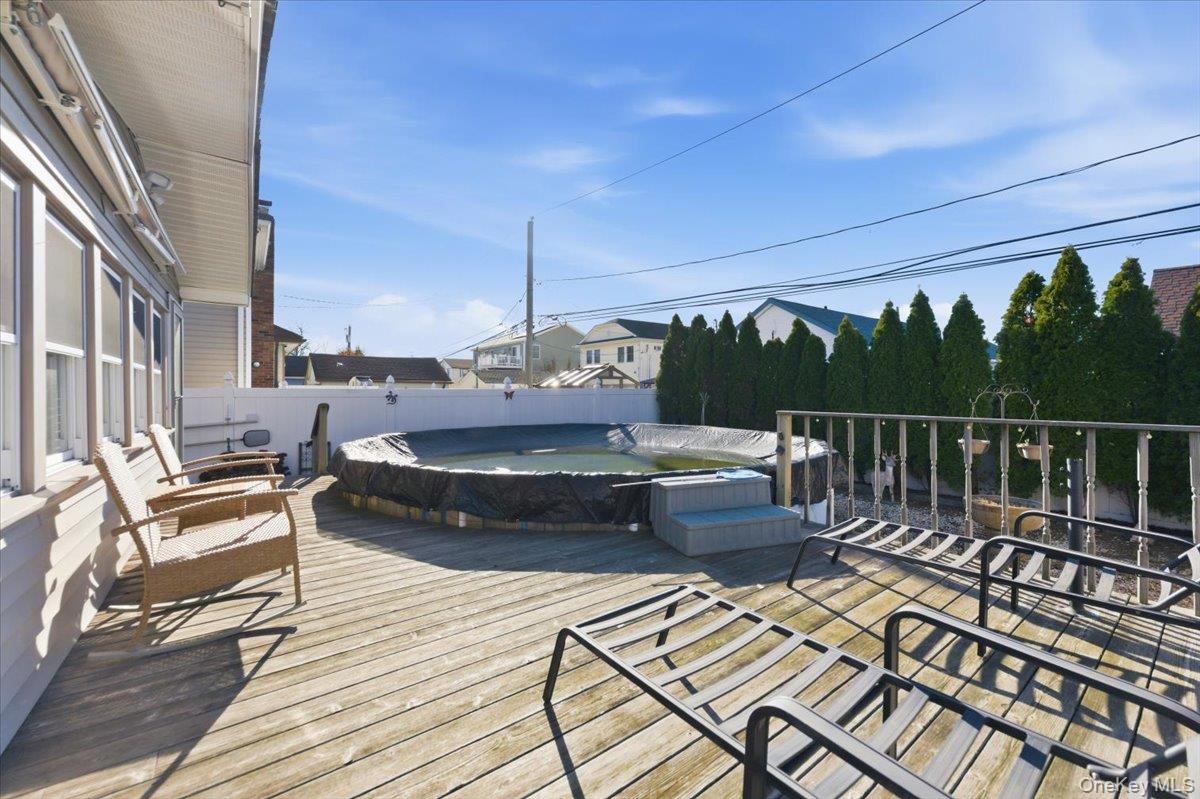 80 Newport Road Island Park, NY 11558 - Photo 19 of 26 a view of balcony with wooden floor and outdoor seating
