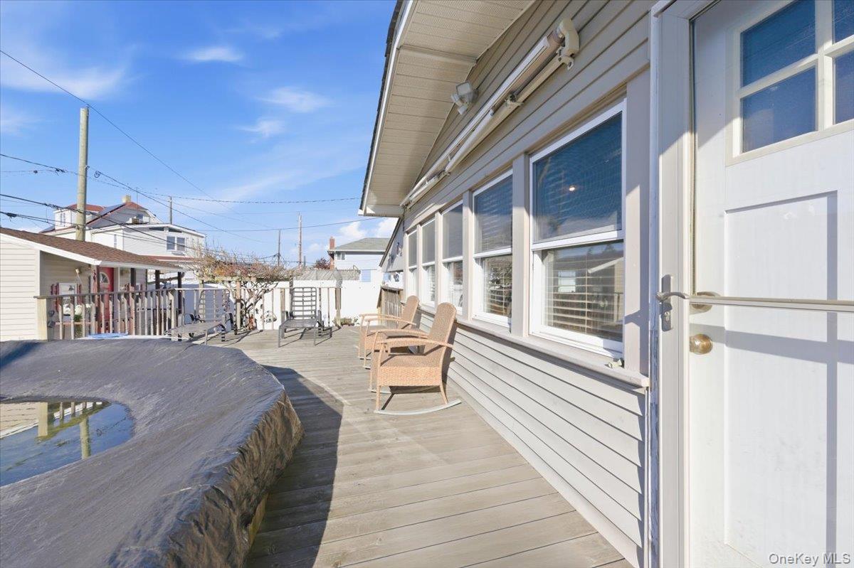 80 Newport Road Island Park, NY 11558 - Photo 20 of 26 a balcony view with a sink and table