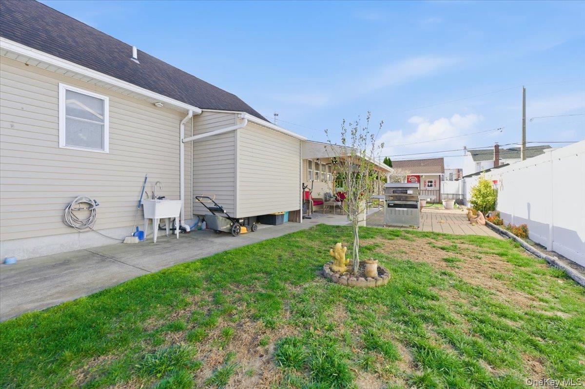 80 Newport Road Island Park, NY 11558 - Photo 21 of 26 a house view with a backyard space