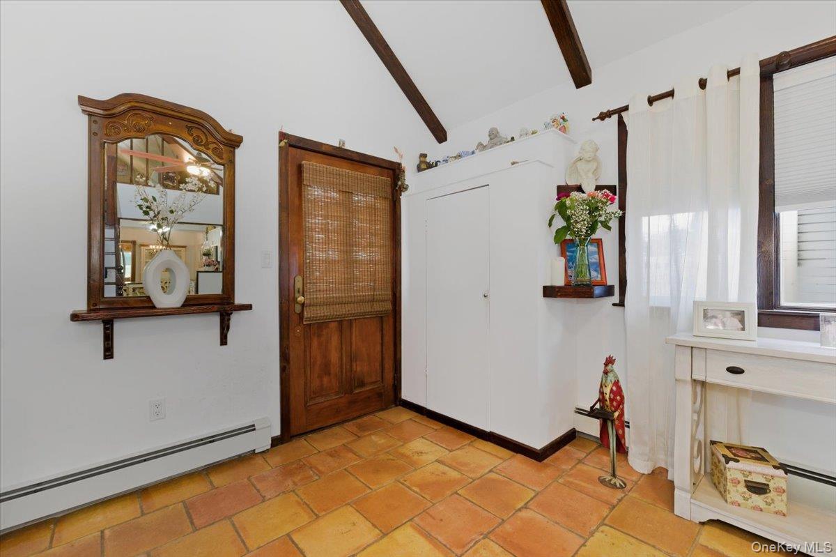 80 Newport Road Island Park, NY 11558 - Photo 4 of 26 a view of hallway with furniture and a window