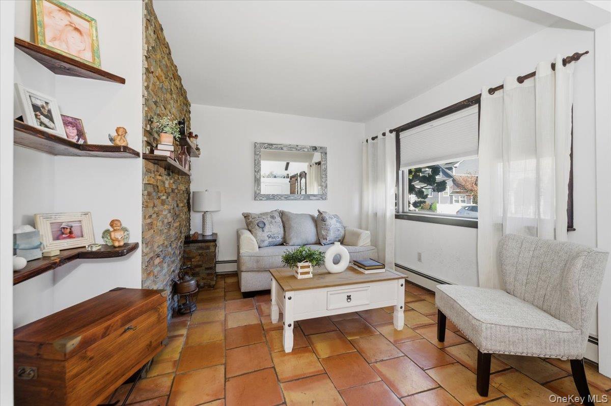 80 Newport Road Island Park, NY 11558 - Photo 5 of 26 a living room with furniture and a painting on the wall