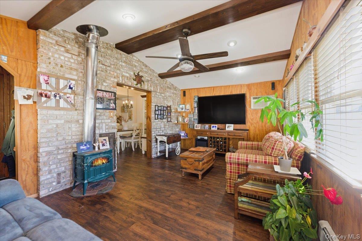 80 Newport Road Island Park, NY 11558 - Photo 10 of 26 a living room with patio furniture and a flat screen tv