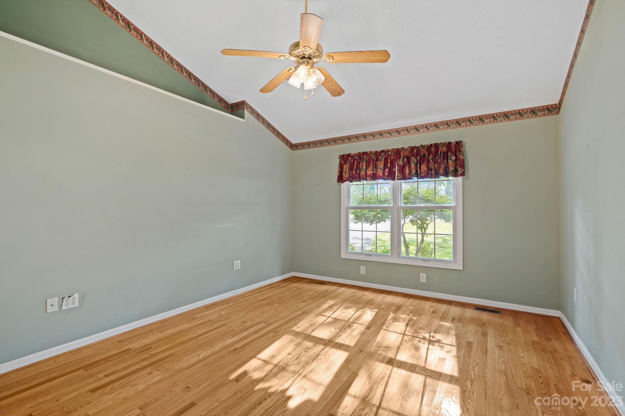 2722 Toddville Road Charlotte, NC 28214 - Photo 15 of 35 an empty room with a window and a ceiling fan