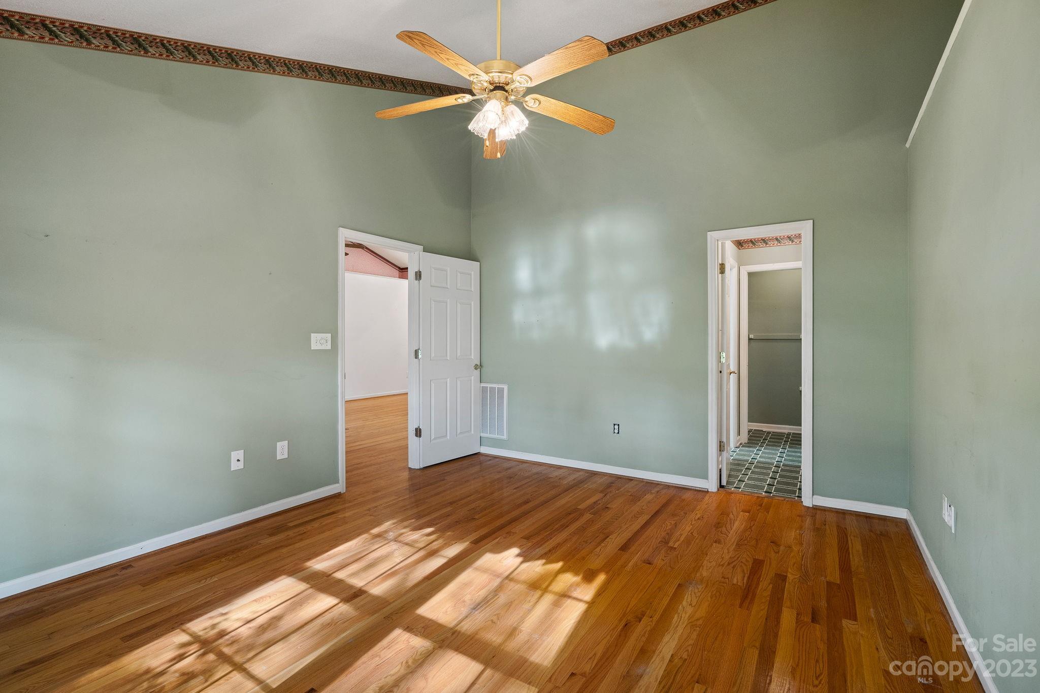 2722 Toddville Road Charlotte, NC 28214 - Photo 16 of 35 a bedroom with a bed and a ceiling fan