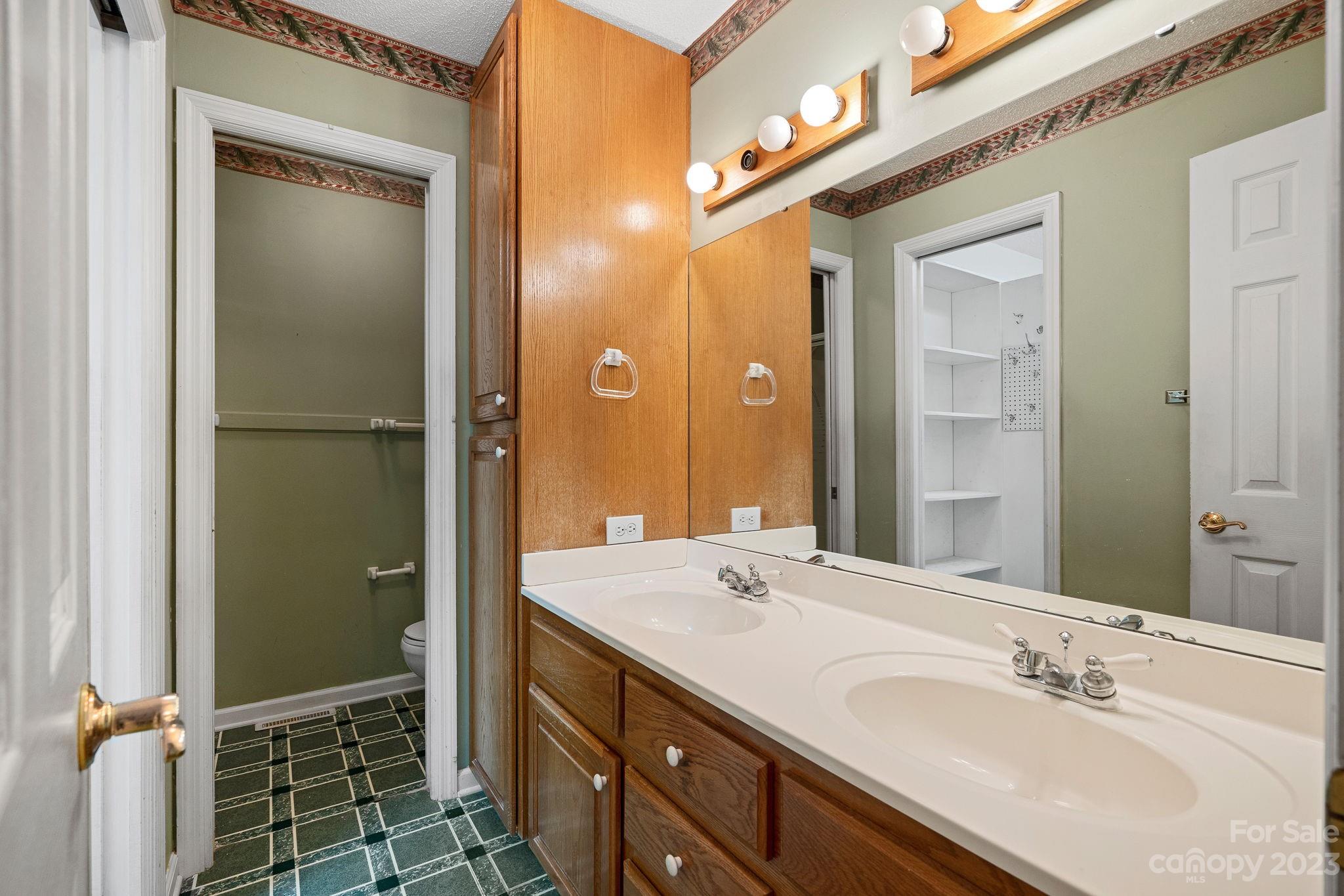2722 Toddville Road Charlotte, NC 28214 - Photo 17 of 35 a bathroom with a double vanity sink mirror and shower