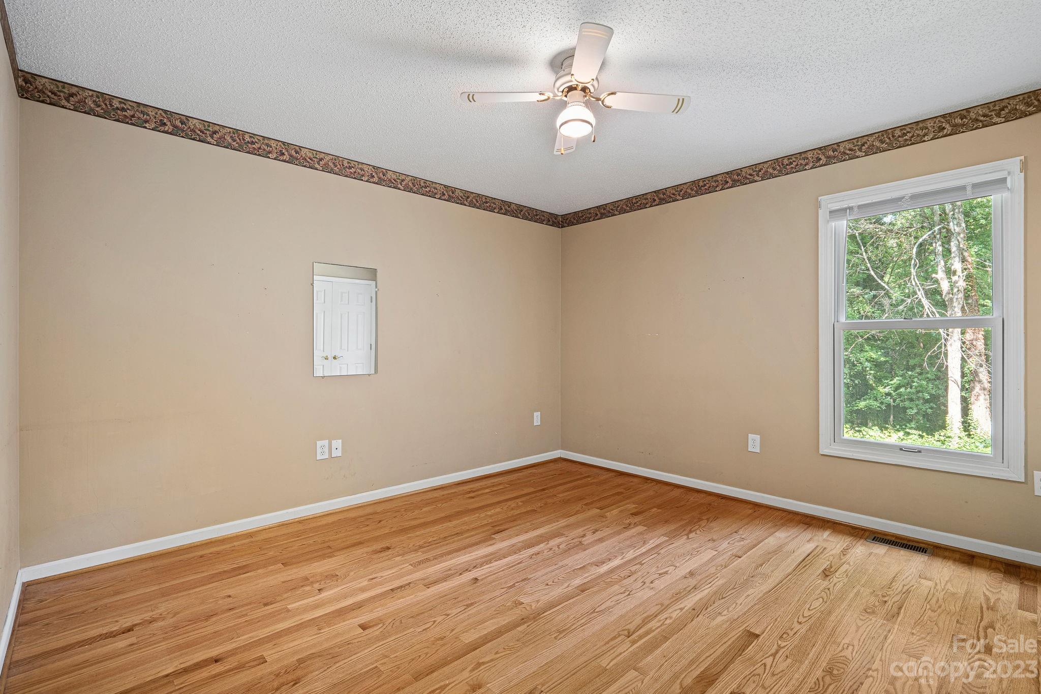 2722 Toddville Road Charlotte, NC 28214 - Photo 20 of 35 a view of a big room with wooden floor and windows