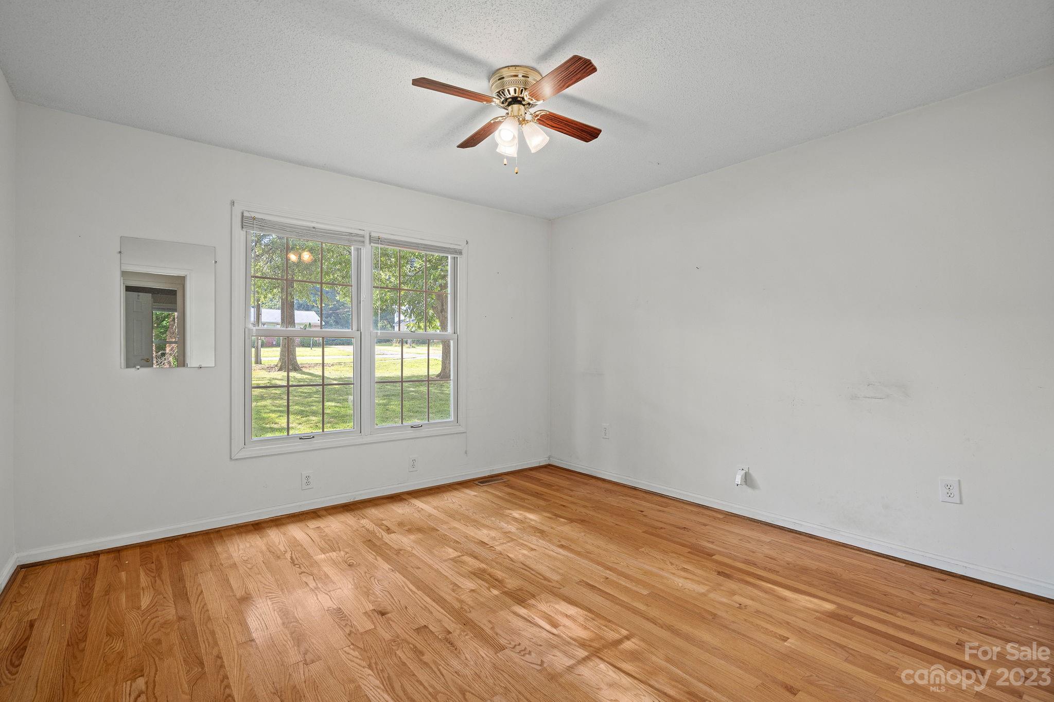2722 Toddville Road Charlotte, NC 28214 - Photo 23 of 35 wooden floor in an empty room with a window