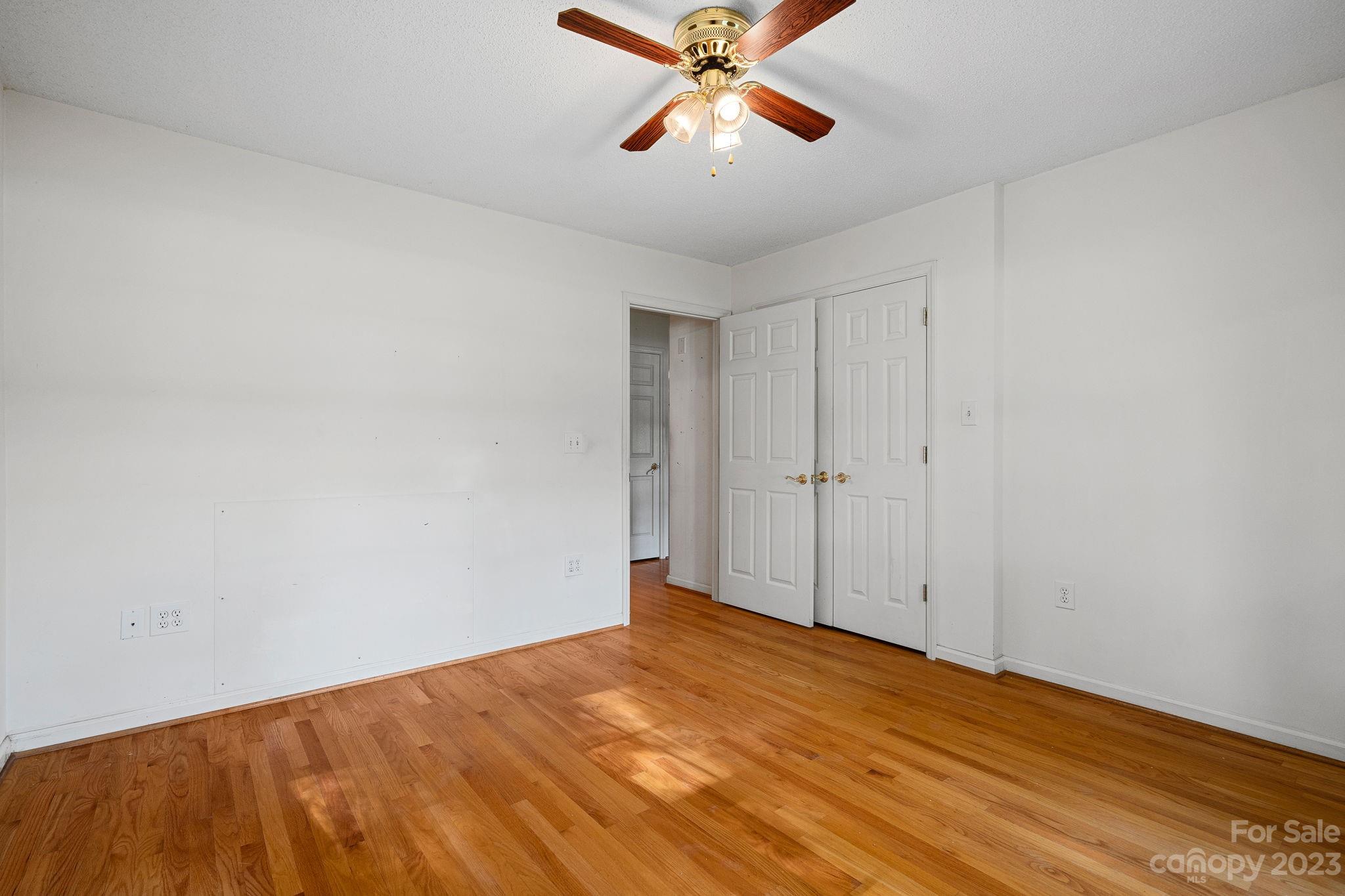 2722 Toddville Road Charlotte, NC 28214 - Photo 24 of 35 a view of a big room with wooden floor and closet in a room