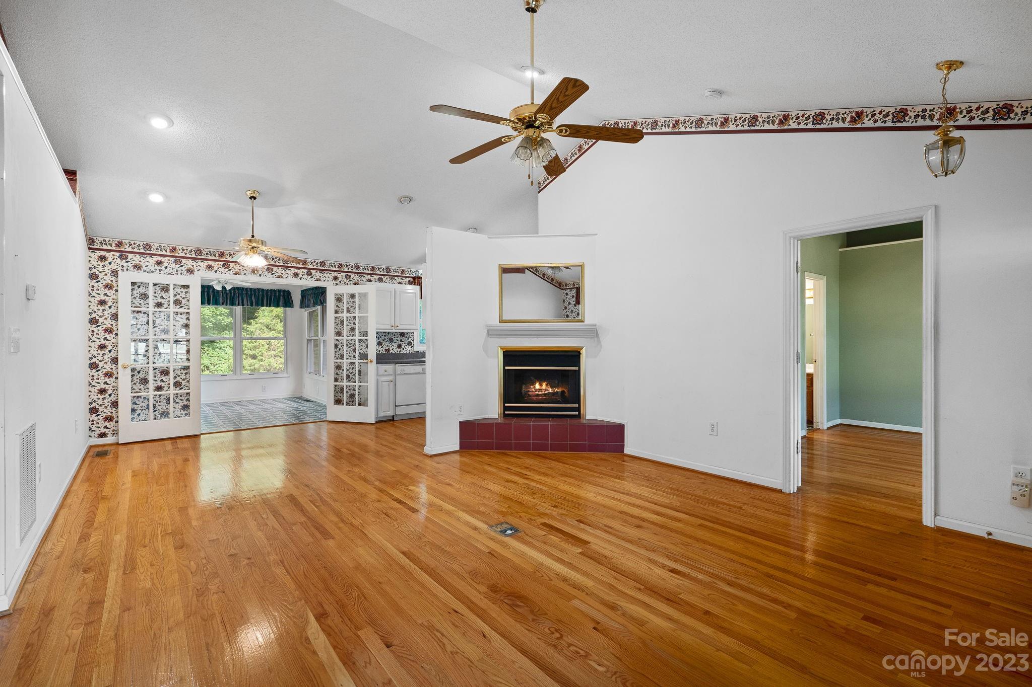 2722 Toddville Road Charlotte, NC 28214 - Photo 4 of 35 a view of empty room with wooden floor and fireplace