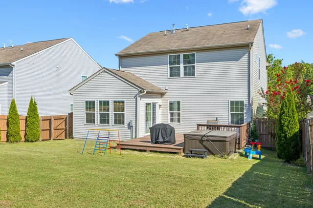a view of a house with patio and a yard
