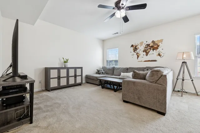 a living room with furniture and a chandelier