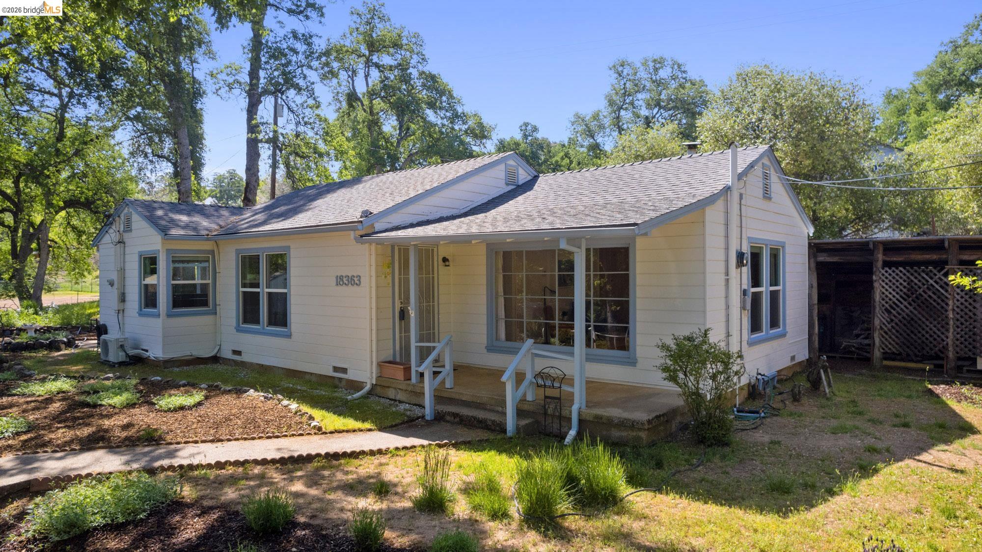 18363 Yosemite Road Tuolumne, CA 95379 - Photo 1 of 34 Charming single-story residence featuring light-colored siding, a covered front entry, and a pitched roof