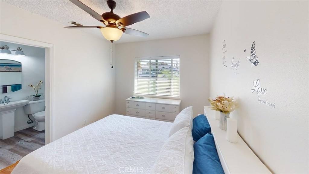 3333 West Keys Lane Anaheim, CA 92804 - Photo 19 of 31 a bedroom with a bed and a chandelier