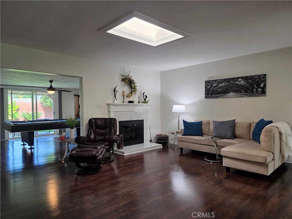 3333 West Keys Lane Anaheim, CA 92804 - Photo 2 of 31 a living room with furniture a fireplace and a flat screen tv