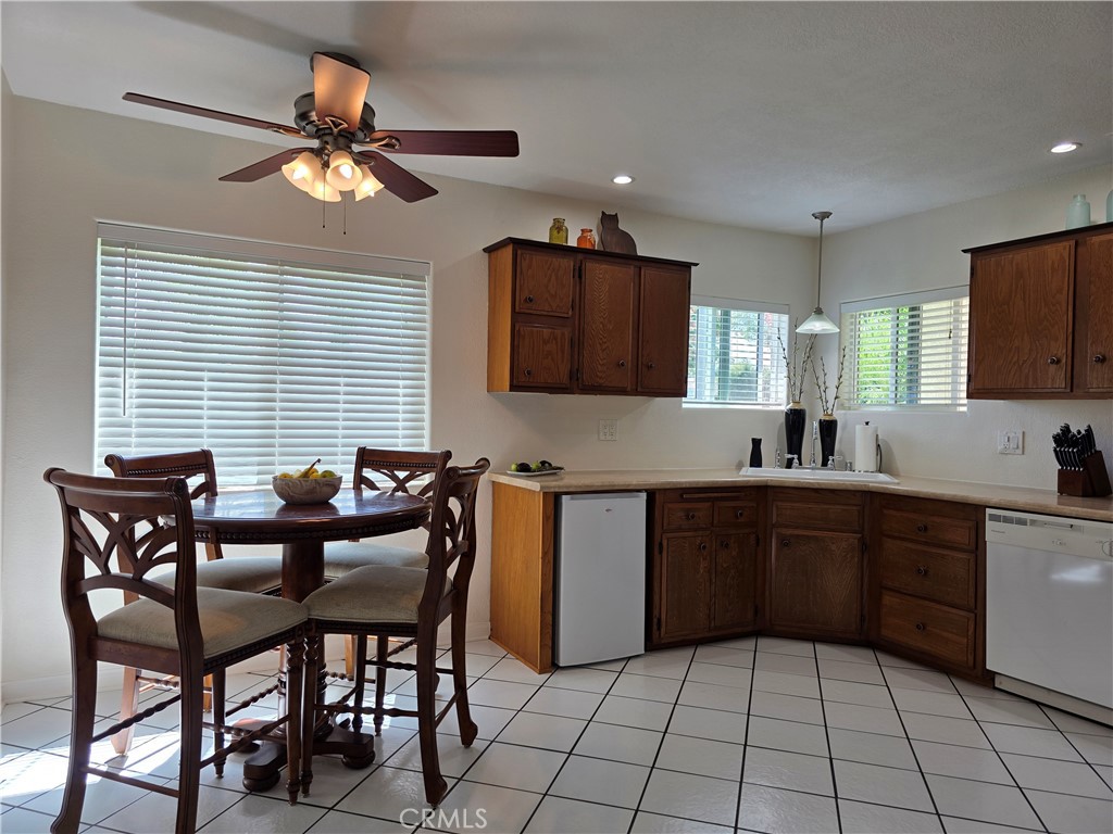 3333 West Keys Lane Anaheim, CA 92804 - Photo 5 of 31 a kitchen with stainless steel appliances granite countertop a sink a stove a dining table and chairs