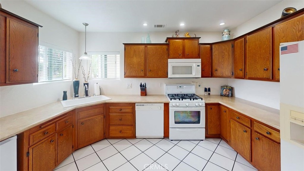 3333 West Keys Lane Anaheim, CA 92804 - Photo 6 of 31 a kitchen with stainless steel appliances granite countertop a stove sink and cabinets