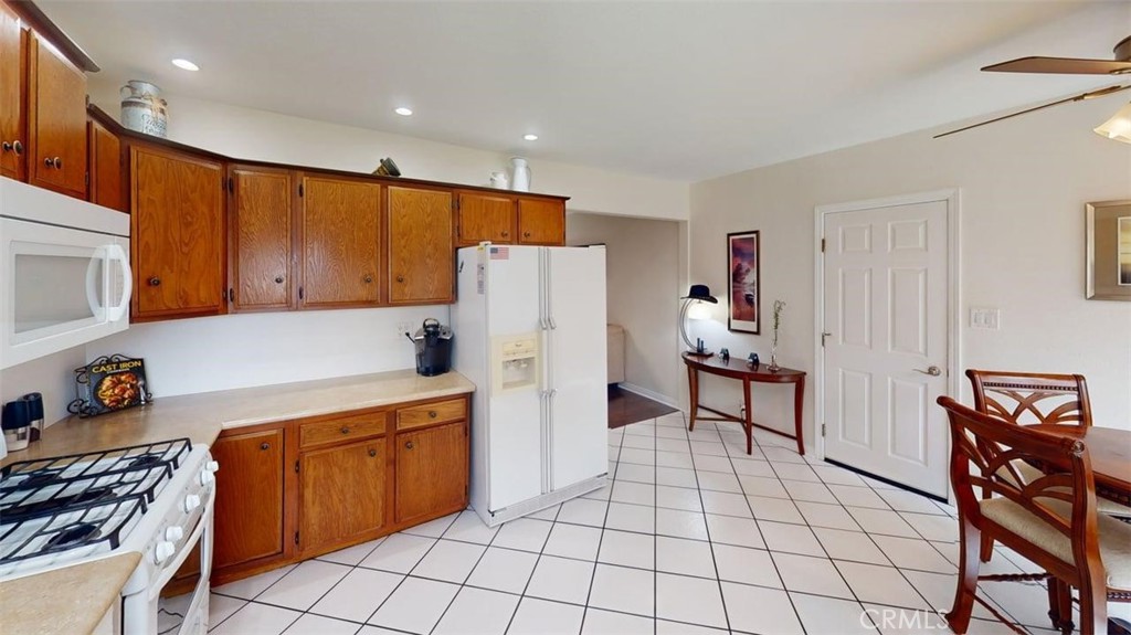 3333 West Keys Lane Anaheim, CA 92804 - Photo 7 of 31 a kitchen with a sink a stove and a refrigerator