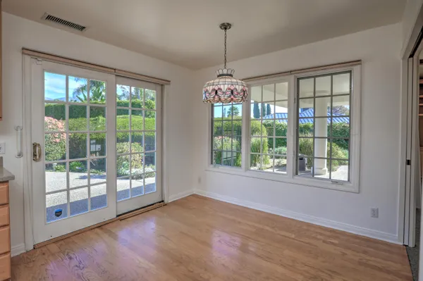 a bathroom with a granite countertop double vanity sink a mirror and a bathtub