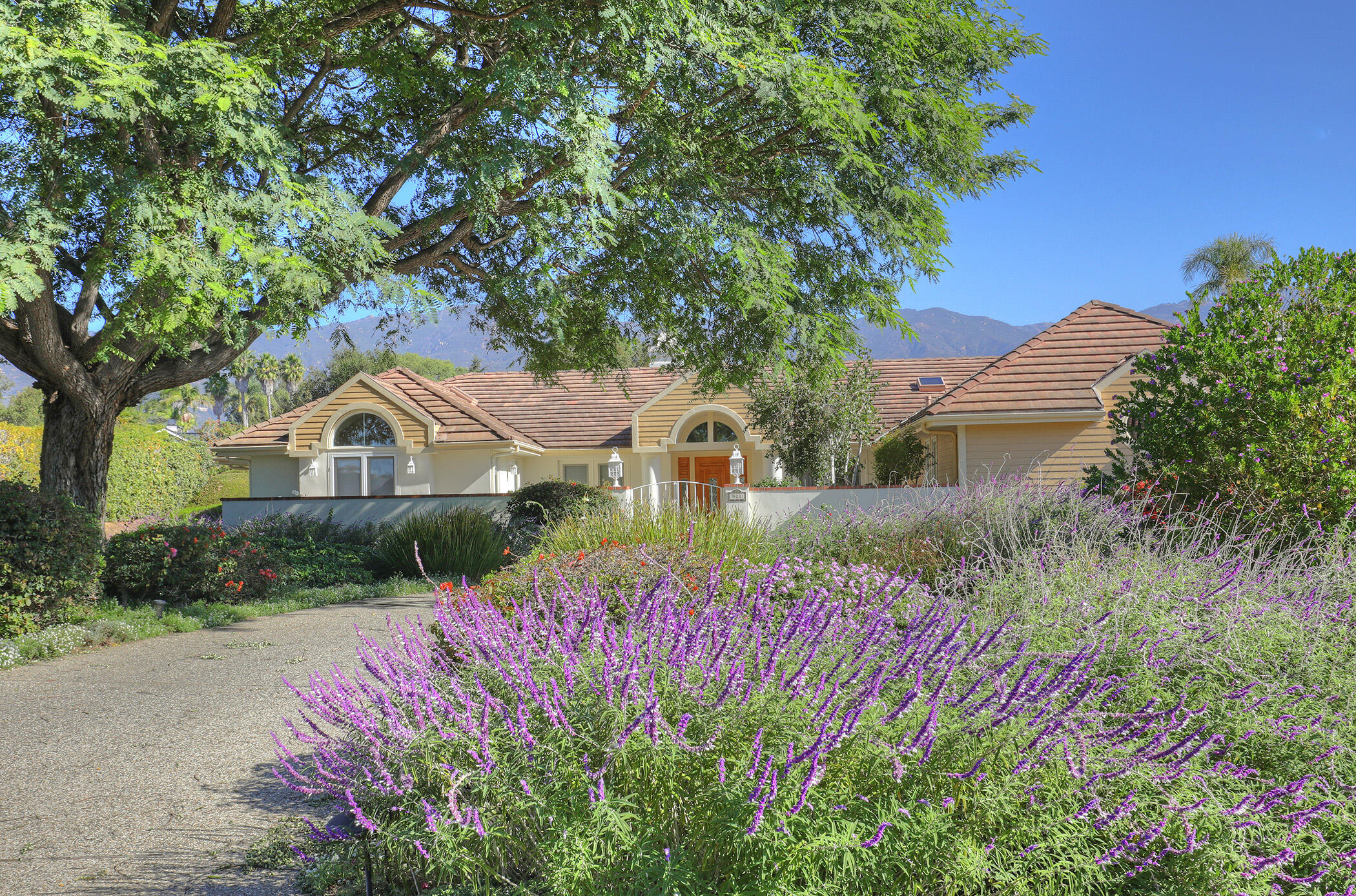 923 Via Los Padres Santa Barbara, CA 93111 - Photo 3 of 36 a front view of a house with a yard and garage