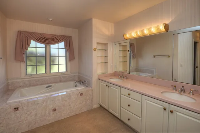 a bathroom with a granite countertop sink a mirror and a shower