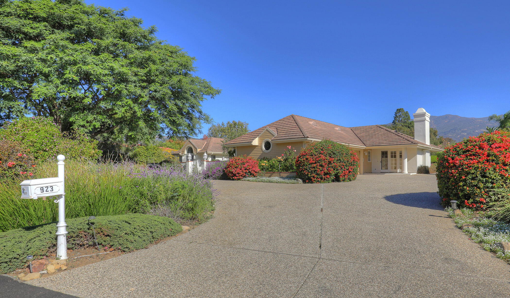 923 Via Los Padres Santa Barbara, CA 93111 - Photo 4 of 36 a front view of a house with a yard and garage