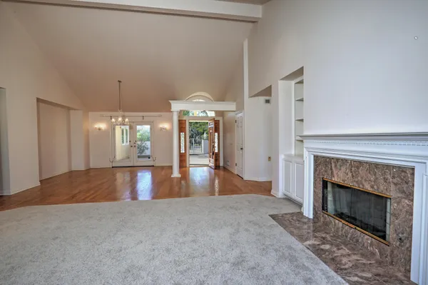 a view of empty room with wooden floor and city view