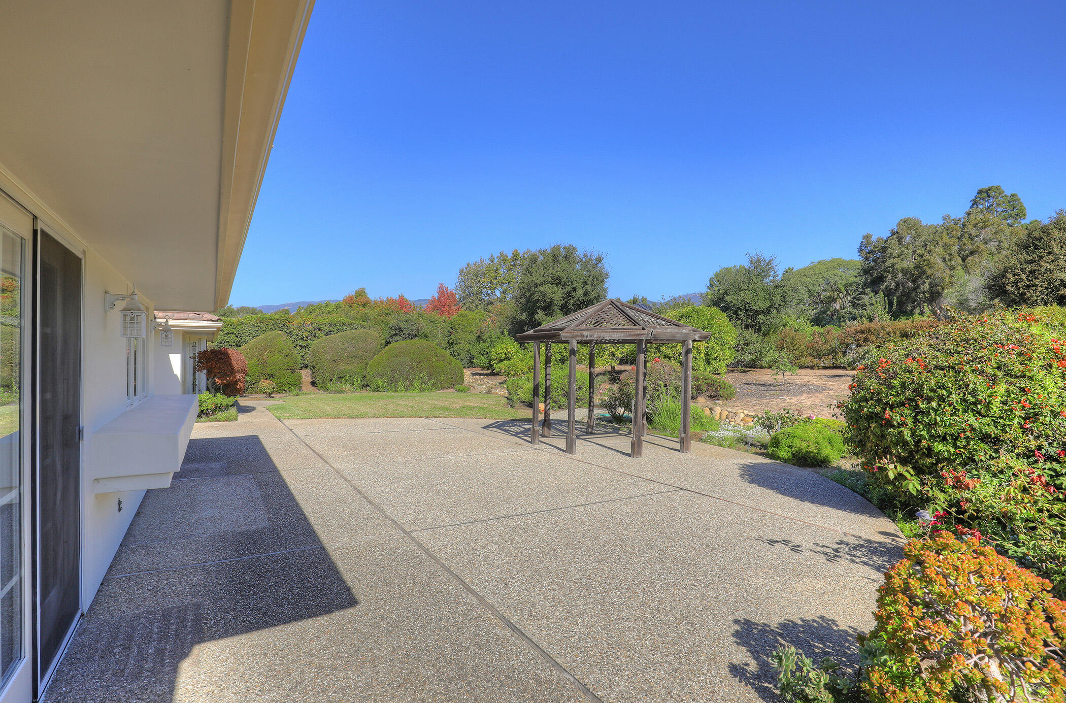 923 Via Los Padres Santa Barbara, CA 93111 - Photo 8 of 36 a view of a patio with table and chairs under an umbrella