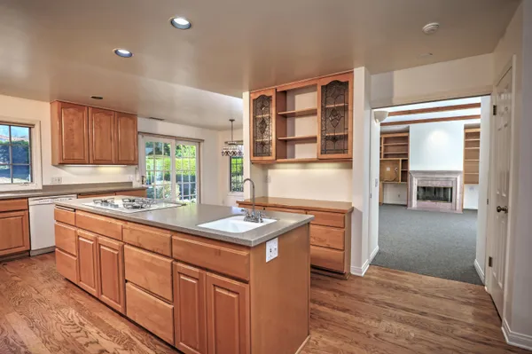 an empty room with furniture staircase and windows
