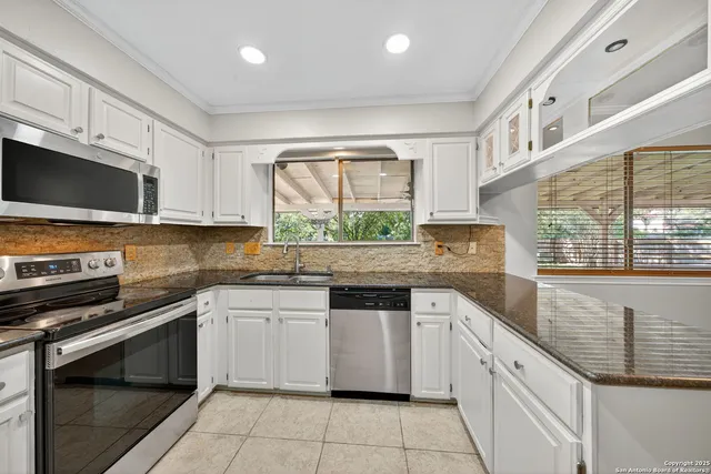 a kitchen with stainless steel appliances granite countertop a stove and a sink