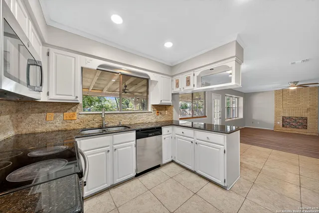 a kitchen with a sink stove and cabinets