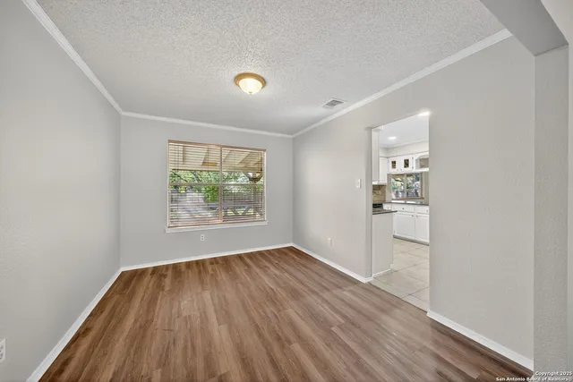 wooden floor in an empty room with a window