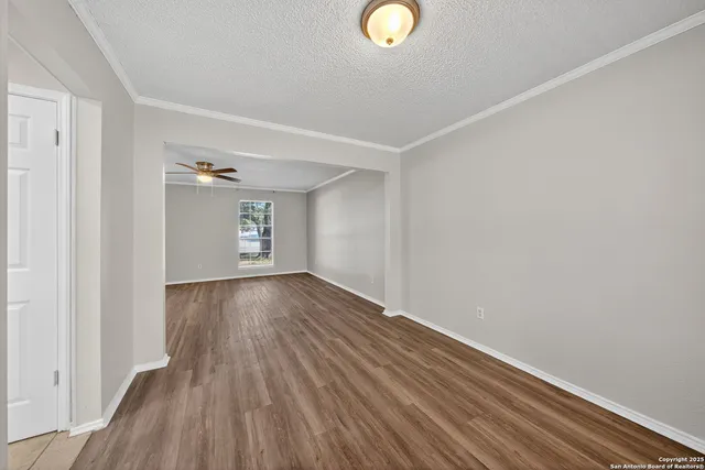 a view of an empty room and wooden floor